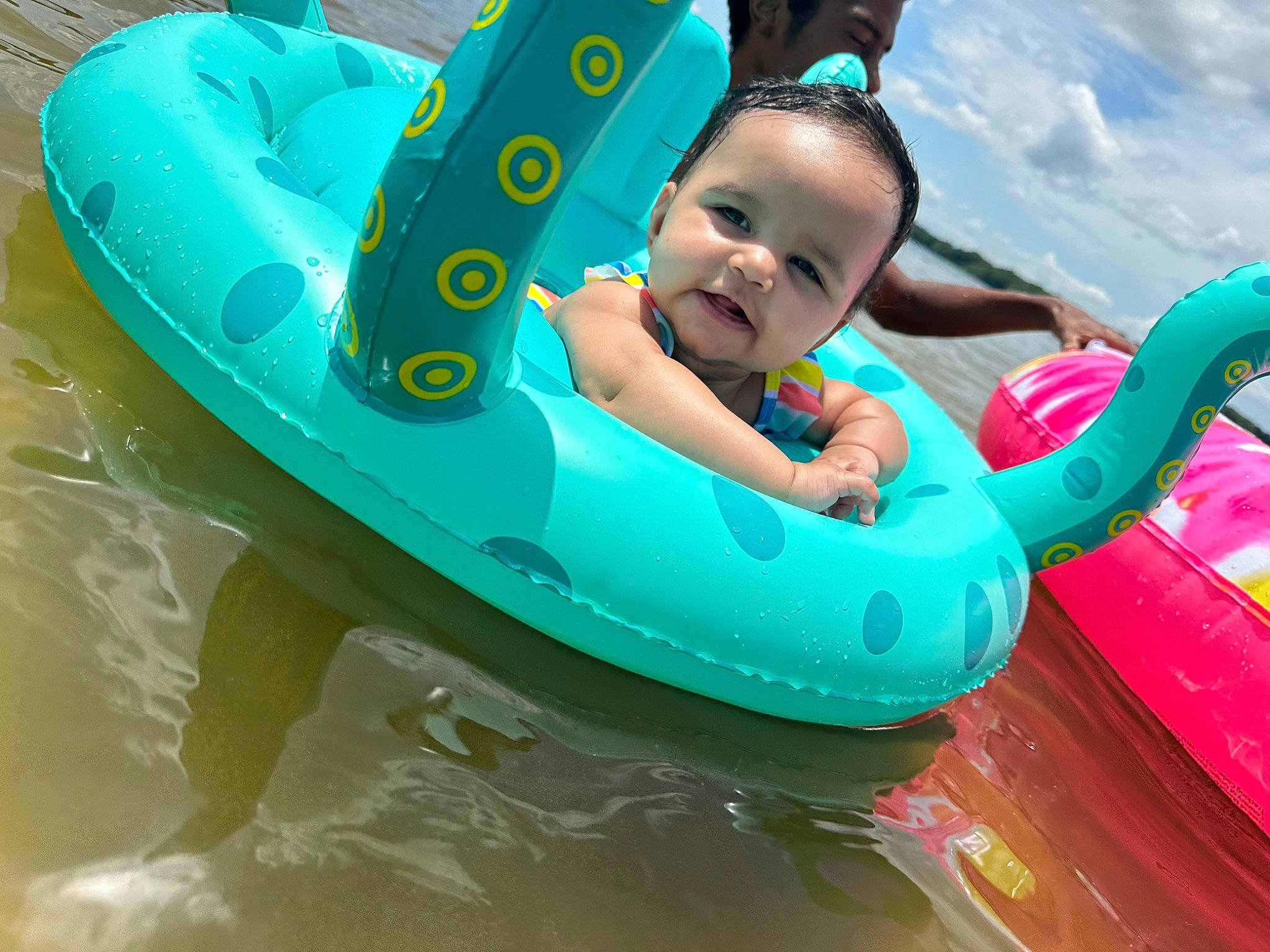 Tru is registered to the contest to win money with this photo: amusement_park, aqua, baby, baby_float, baby_toddler_clothing, boats_and_boating_equipment_and_supplies, child, cloud, fun, happy, inflatable, leisure, nonbuilding_structure, person, personal_protective_equipment, play, recreation, sky, smile, toddler