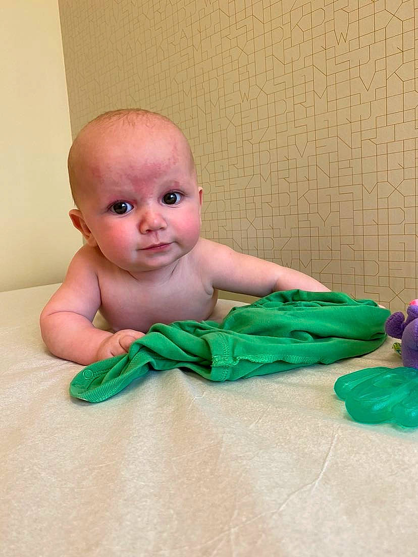 Kingston is registered to the contest to win money with this photo: baby, baby_toddler_clothing, bedding, chest, child, comfort, dress, flesh, flooring, foot, fun, grass, hardwood, linens, peach, person, plastic, room, sitting, toddler