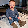 Carter joined the competition — help win amazing prizes! child, baby, toddler, sitting, blue_sweater, jeans, brown_boots, blanket, carpet, indoor, smiling, blue_eyes, hands, face, portrait, door, exercise_equipment, flash_lighting, floor, cozy