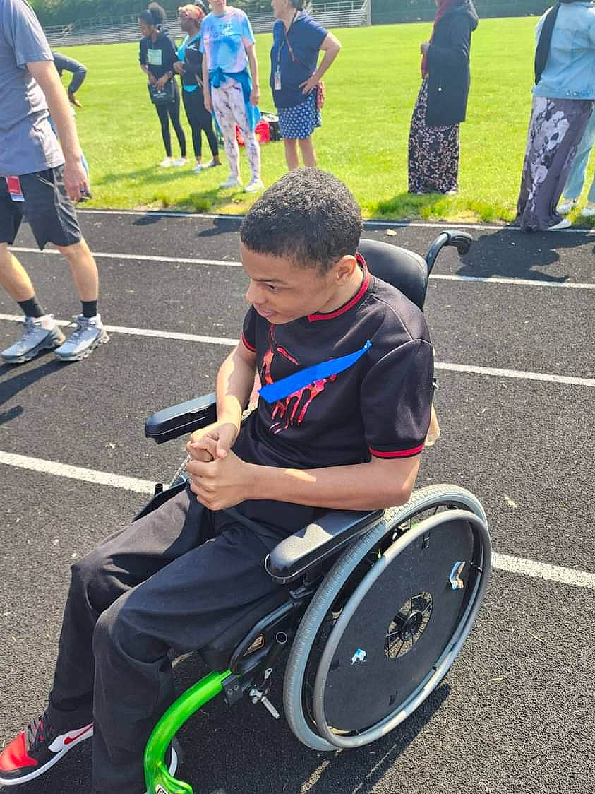 Edwin joined the competition — help win amazing prizes! automotive_tire, clothing, competition_event, disabled_sports, event, fun, green, human_leg, knee, person, player, recreation, rolling, shorts, sitting, sports, t_shirt, tire, wheel, wheelchair
