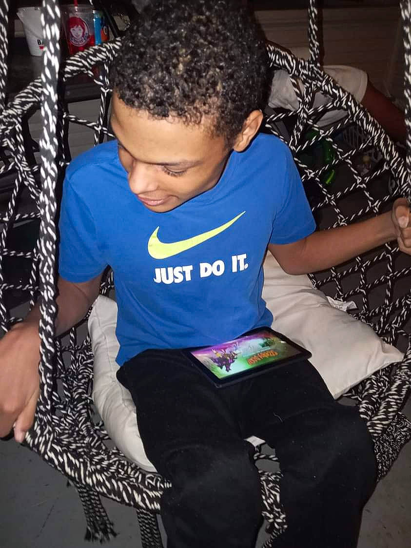 Edwin is registered to the contest to win money with this photo: black_hair, child, cool, elbow, electric_blue, event, eyewear, flash_photography, fun, jewellery, joint, knee, leisure, magenta, pattern, person, sitting, sleeve, t_shirt, textile