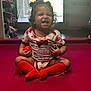 Zamira joined the competition — help win amazing prizes! toddler, child, smiling, sitting, red_socks, onesie, indoor, ball, curly_hair, door, window, floor, playful, happy, baby, toy, casual_clothing, home, cute, cross_legged
