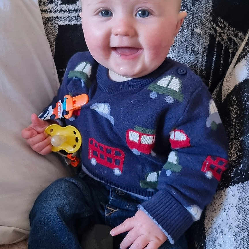 Geoffrey is registered to the contest to win money with this photo: architecture, baby, bodypart, clothing, couch, cushion, face, finger, furniture, hand, head, homedecor, hosiery, jeans, pants, person, photography, portrait, sitting, sock