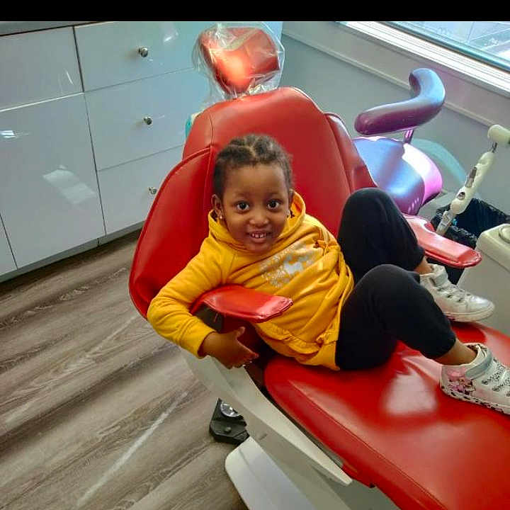 Rasheed is registered to the contest to win money with this photo: bodypart, child, clothing, coat, cushion, face, female, footwear, furniture, girl, head, homedecor, indoors, interiordesign, pants, person, photography, playarea, portrait, shoe