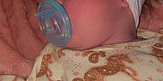 Lily is registered to the contest to win money with this photo: baby, sleeping, pacifier, headband, bow, blanket, onesie, horse_pattern, paisley_pattern, pink, white, blue, infant, cozy, soft, cute, child, portrait, closeup, resting