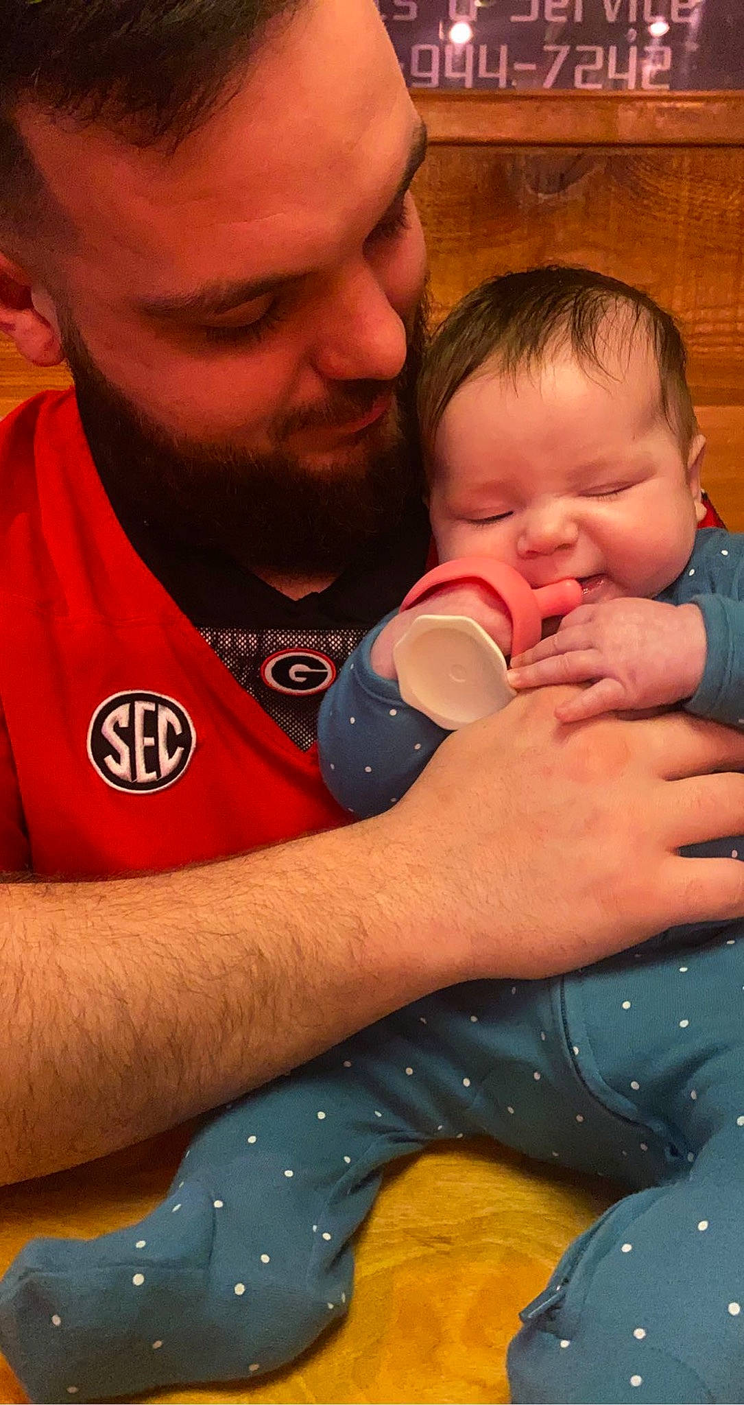 Malia is registered to the contest to win money with this photo: arm, beard, cheek, child, drink, drinking, drinkware, ear, finger, fun, gesture, hand, happy, mouth, nail, nose, orange, organ, person, t_shirt