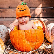 Britduer Gabriel is registered to the contest to win money with this photo: baby, child, infant, pumpkin, halloween, costume, hat, orange, portrait, outdoor, autumn, fall, rustic, wooden_background, straw, farm, seasonal, sitting, wide_eyed, photography