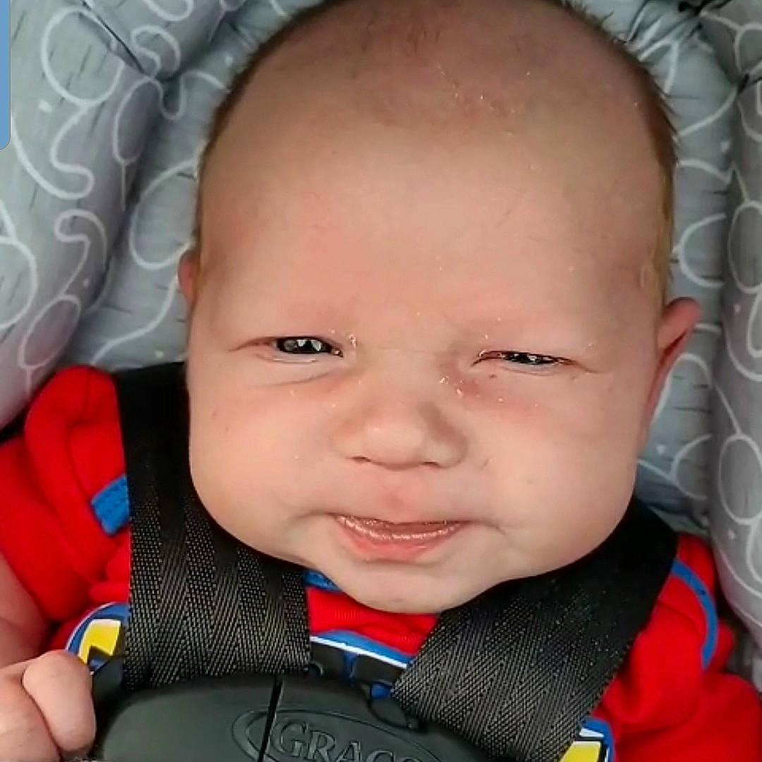 Dillon is registered to the contest to win money with this photo: baby, baby_in_car_seat, cheek, child, chin, ear, eye, eyebrow, face, facial_expression, forehead, head, lip, mouth, nose, person, skin, smile, toddler