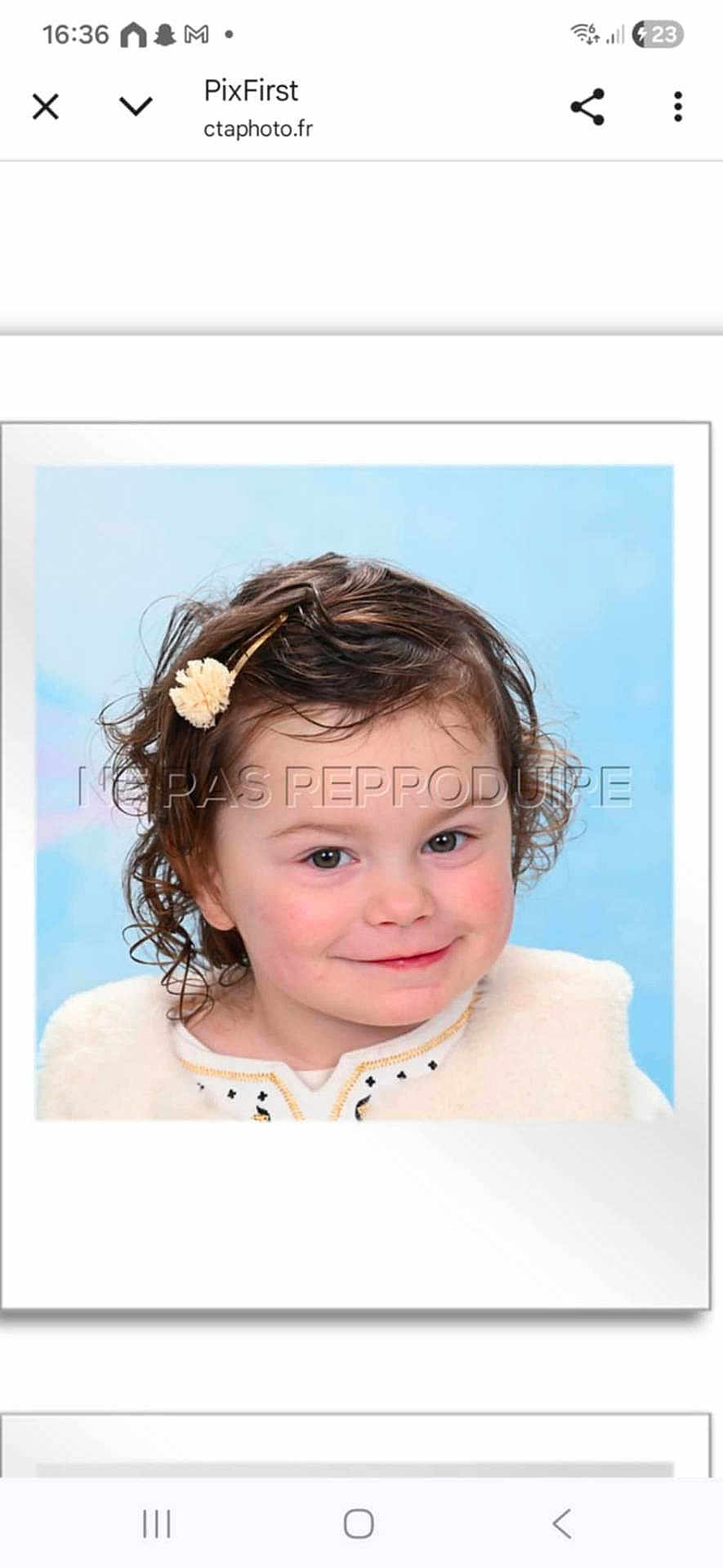 Lucie a rejoint le concours — aidez-le/la à gagner de superbes lots ! child, toddler, portrait, smile, curly_hair, hair_clip, blue_background, studio_portrait, watermark, white_border, framed_photo, rosy_cheeks, green_eyes, face, headshot, clothing, fur_vest, photograph, cute, portrait_smile