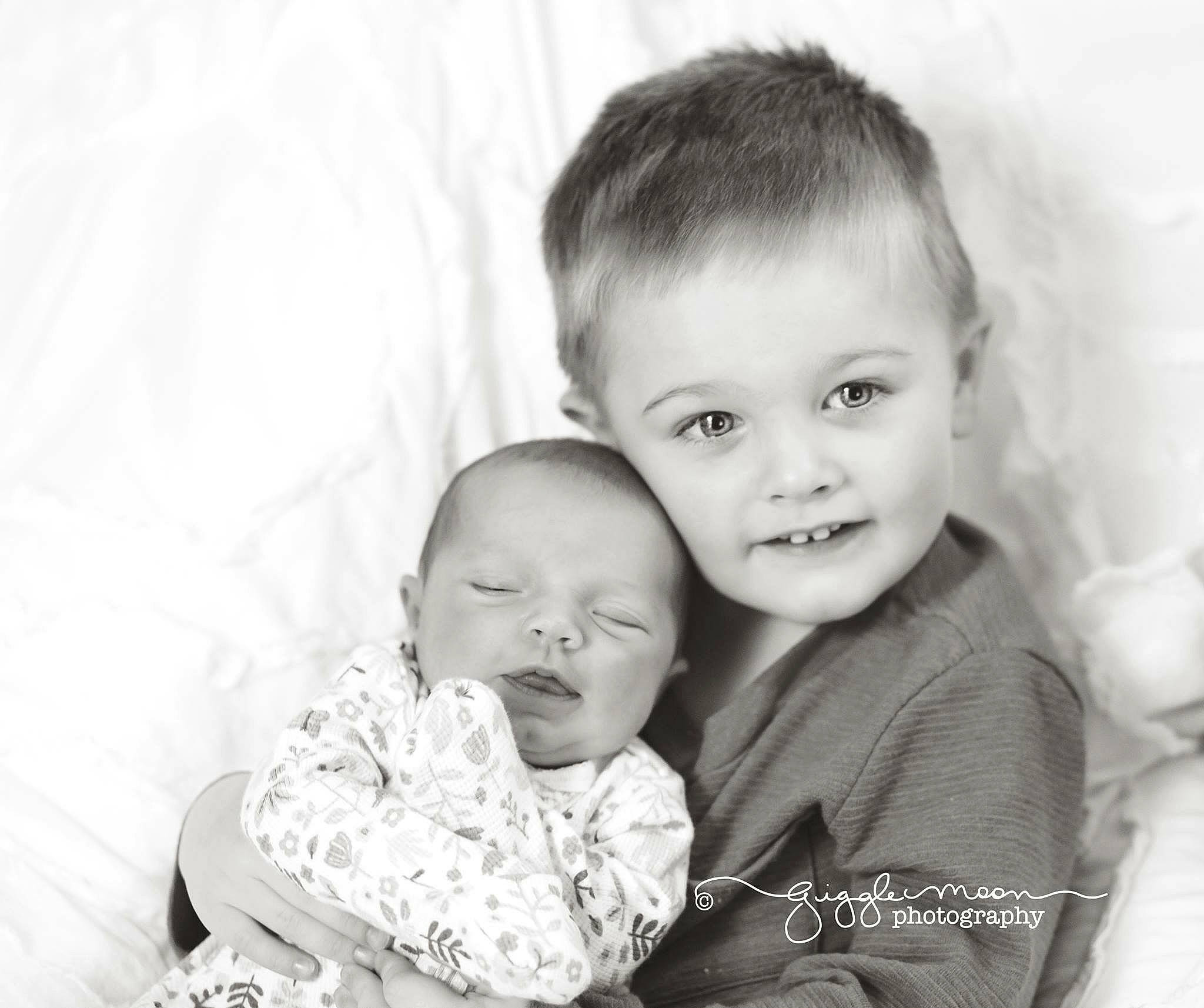 Carson is registered to the contest to win money with this photo: black_and_white, child, facial_expression, family, happiness, infant, iris, laughter, monochrome, monochrome_photography, mother, people, person, photograph, photography, portrait, portrait_photography, sibling, skin, smile