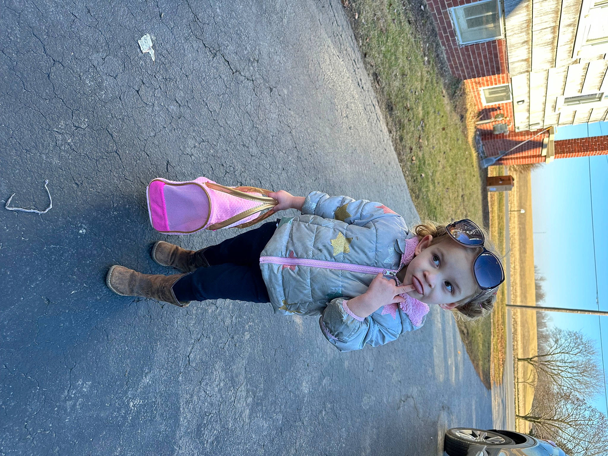 Payton is registered to the contest to win money with this photo: asphalt, boot, child, concrete, denim, electric_blue, fun, headwear, helmet, human_leg, jeans, leisure, outdoor_shoe, person, plant, recreation, road_surface, sneakers, toddler, travel