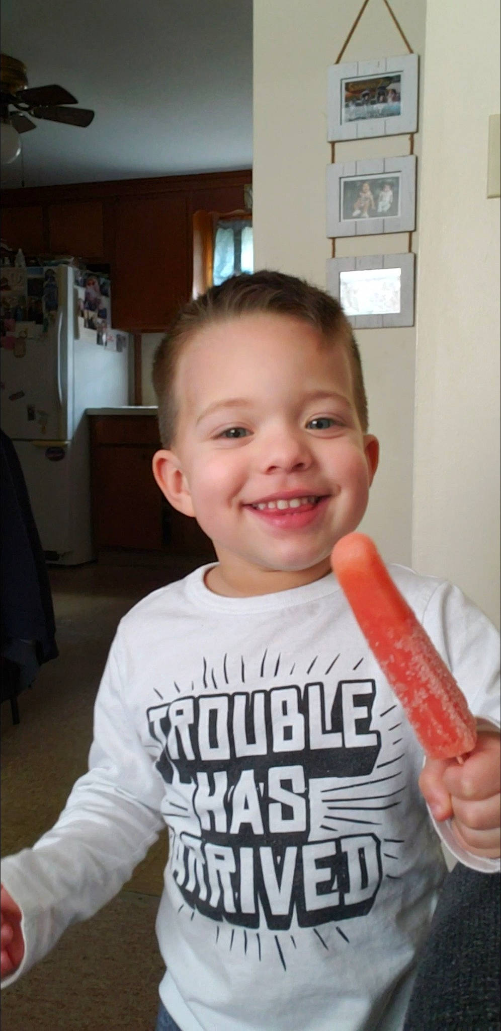 Jullian is registered to the contest to win money with this photo: active_shirt, arm, child, chin, dessert, finger, food, frozen_dessert, fun, gesture, happy, ice_cream, ice_pop, joint, joy, person, sleeve, smile, sweetness, t_shirt