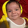 Jesse joined the competition — help win amazing prizes! baby, smile, face, yellow_outfit, child, closeup, portrait, cute, infant, red_background, happy, clothing, person, indoors, young_child, costume, head, skin, eyes, baby_fashion