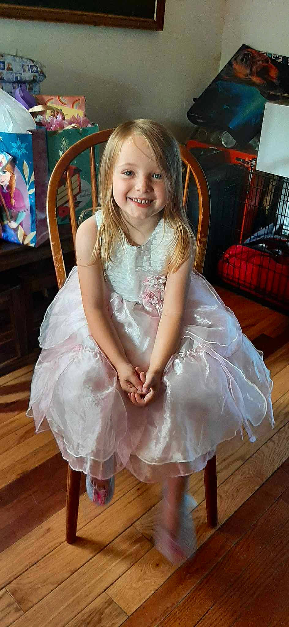 Eva is registered to the contest to win money with this photo: baby_toddler_clothing, blond, child, day_dress, dress, embellishment, event, fashion_design, floor, flooring, formal_wear, fun, happy, hardwood, joy, laminate_flooring, lamp, person, pink, smile