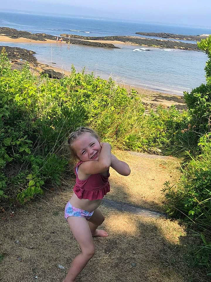 Eva is registered to the contest to win money with this photo: baby, beach, ecoregion, grass, grass_family, happy, head, human_body, joy, lake, landscape, leisure, people_in_nature, person, plant, sky, summer, sunlight, swimwear, thigh