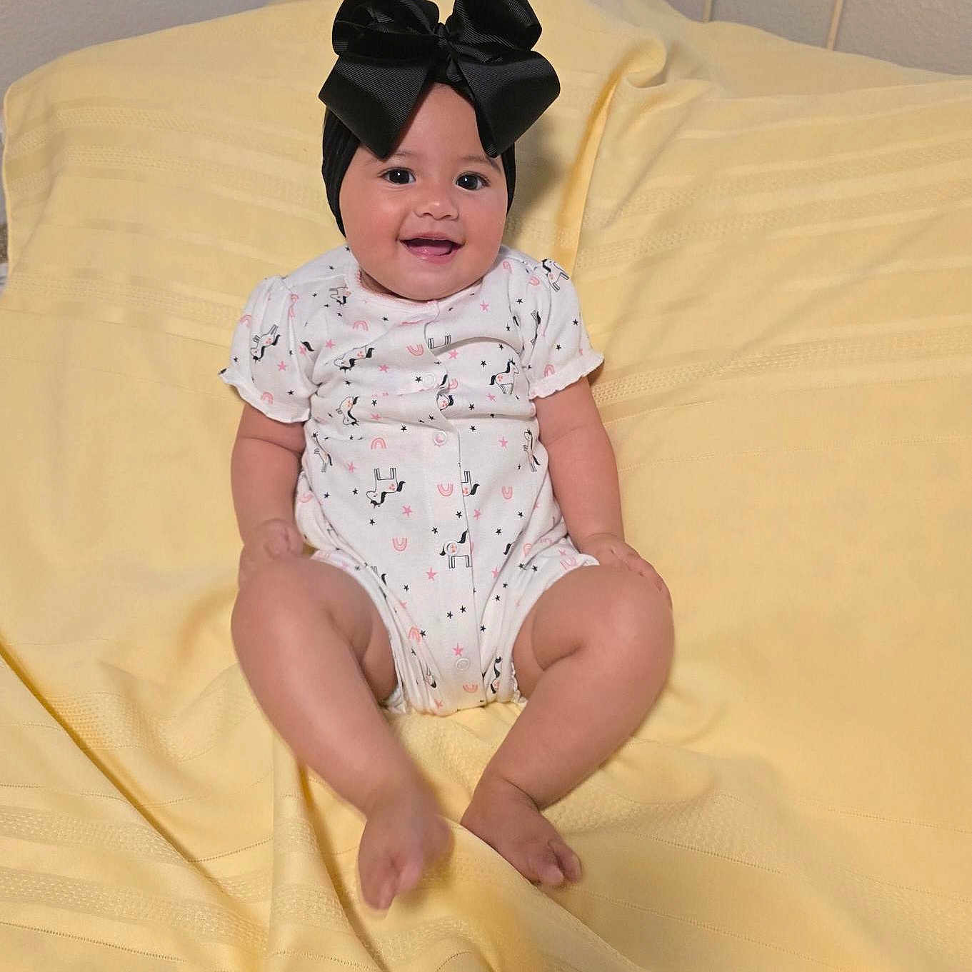 Ava joined the competition — help win amazing prizes! baby, babylaughing, bed, bedroom, clothing, cushion, face, furniture, happy, hat, head, homedecor, indoors, person, photography, portrait, room, sitting, sleeve, smile
