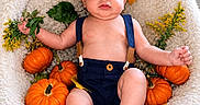 Bellamy is registered to the contest to win money with this photo: baby, child, infant, portrait, autumn, pumpkins, leaves, flowers, hat, cap, suspenders, overalls, sandals, seated, lying_down, smiling, indoors, blanket, window, seasonal_decor