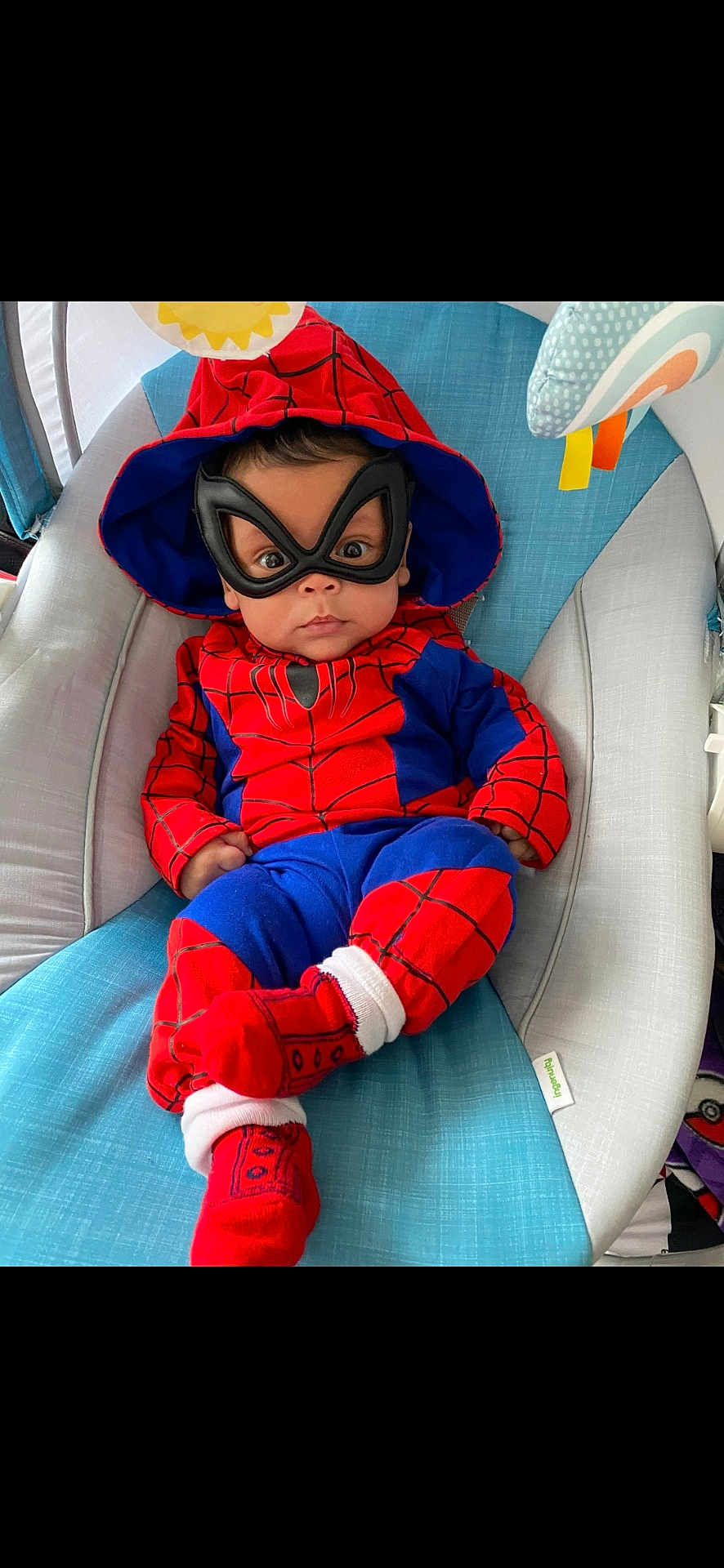 Kayden joined the competition — help win amazing prizes! baby, child, costume, spiderman, mask, hood, red, blue, socks, seat, baby_seat, indoor, cute, infant, portrait, clothing, person, resting, young, casual