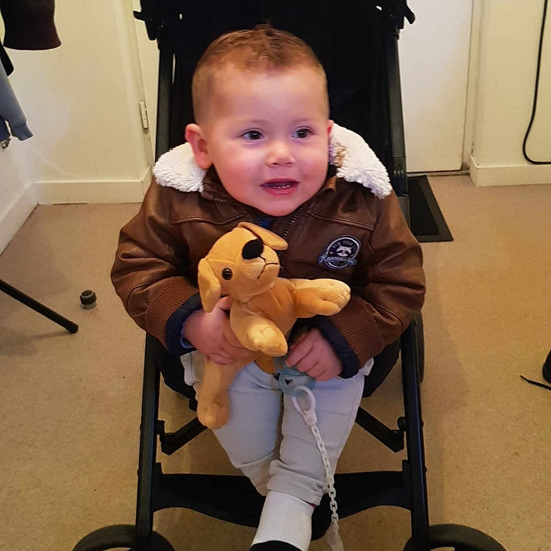 Stan Pillon participe au concours pour gagner de l'argent avec cette photo : baby, carpet, child, clothing, cute, dog_toy, door, face, hand, happy, indoor, jacket, keys, pacifier, person, plush_toy, seated, stroller, toddler, wheel