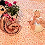 baby, infant, child, bow_headband, diaper, feet, blanket, daisies_pattern, pink, plush_toy, minnie_mouse, stuffed_animal, balloon, rose_bouquet, plant, basket, toys, celebration, cozy, portrait