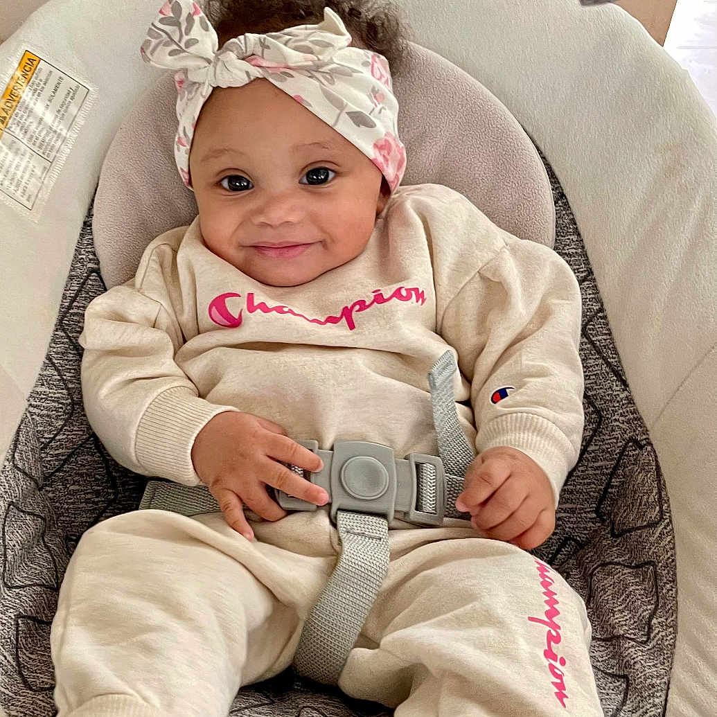 Keyari joined the competition — help win amazing prizes! baby, baby_seat, champion_clothing, child, clothing, comfortable, curly_hair, cushion, cute, feet, hands, happy, headband, indoor, infant, person, portrait, seatbelt, smiling, socks