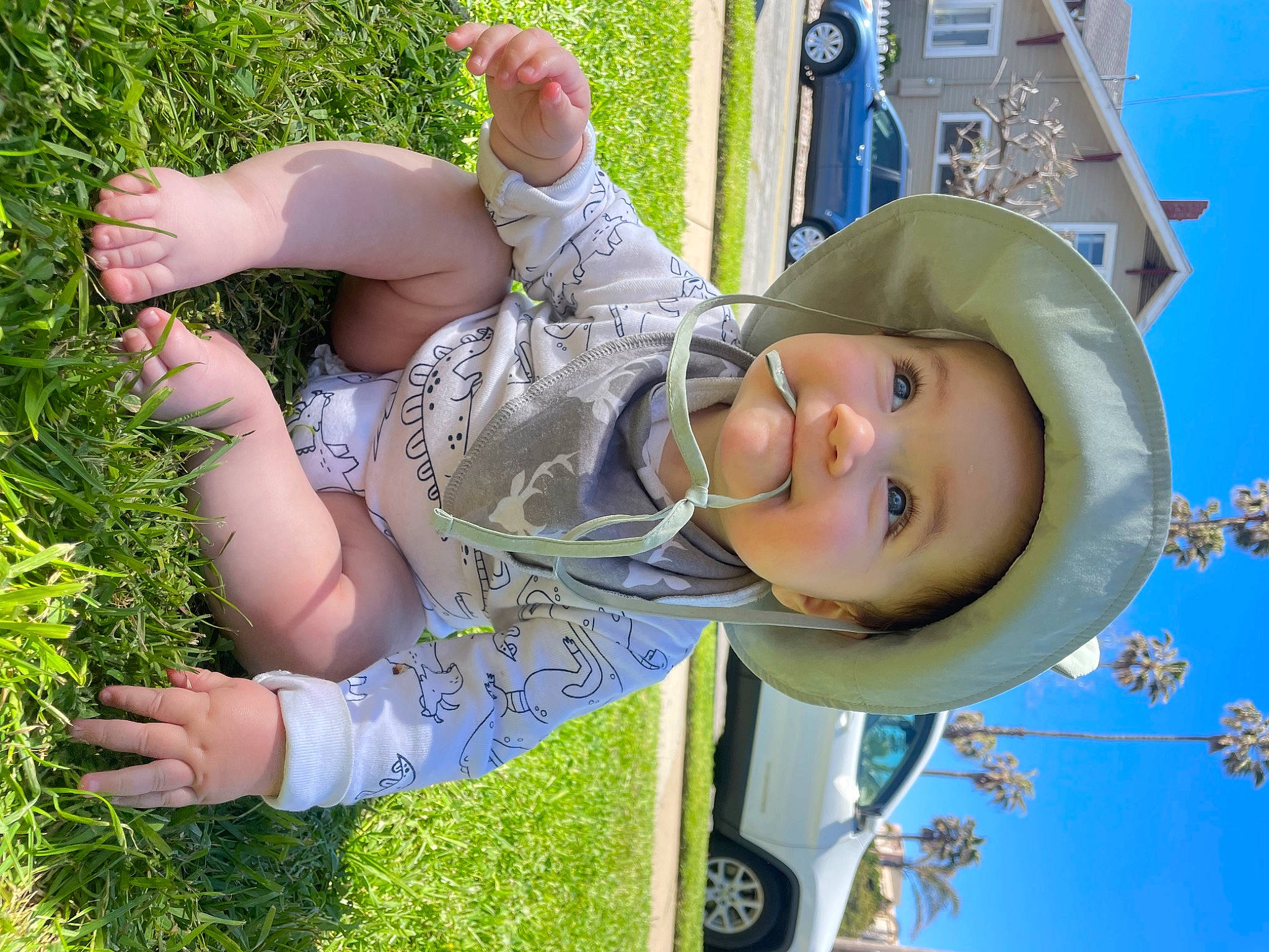 Sullivan is registered to the contest to win money with this photo: beauty, child, fun, grass, green, happy, hat, headwear, leaf, leisure, outdoor_play_equipment, people_in_nature, person, plant, recreation, sky, smile, summer, sun_hat, swing