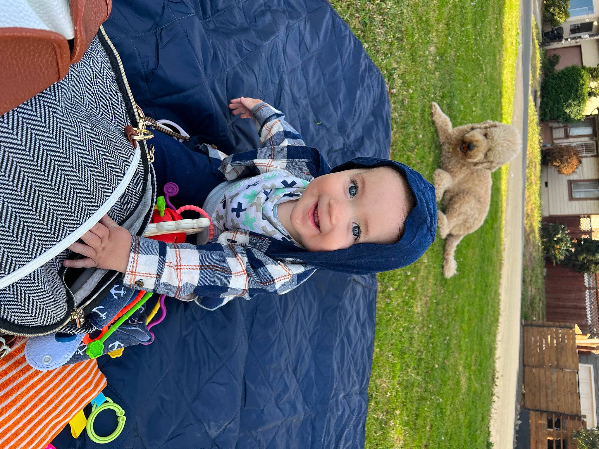 Sullivan is registered to the contest to win money with this photo: baby, child, fawn, fun, grass, happy, hat, headwear, joy, leaf, leisure, pattern, person, plaid, plant, recreation, spring, tartan, textile, toddler