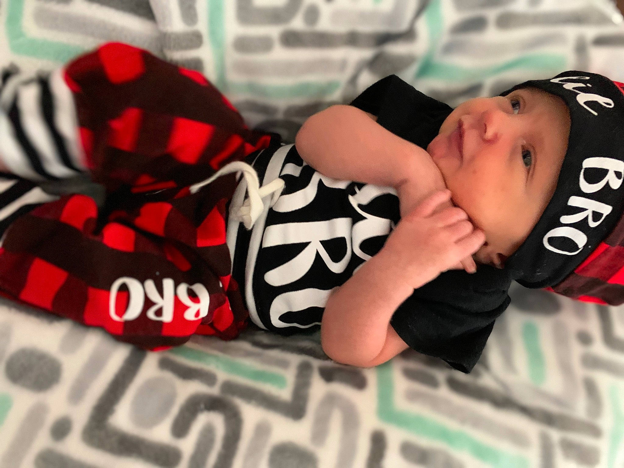 Briar is registered to the contest to win money with this photo: black_hair, cap, carmine, elbow, eyewear, fashion_accessory, font, headwear, pattern, person, personal_protective_equipment, sitting, sleeve, toddler