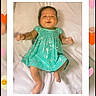 baby, infant, child, portrait, smiling, lying_down, turquoise_dress, heart_pattern, blanket, indoor, close_up, face, hands, bare_feet, soft_lighting, decorative_frame, hearts, flowers, date_text, hashtag