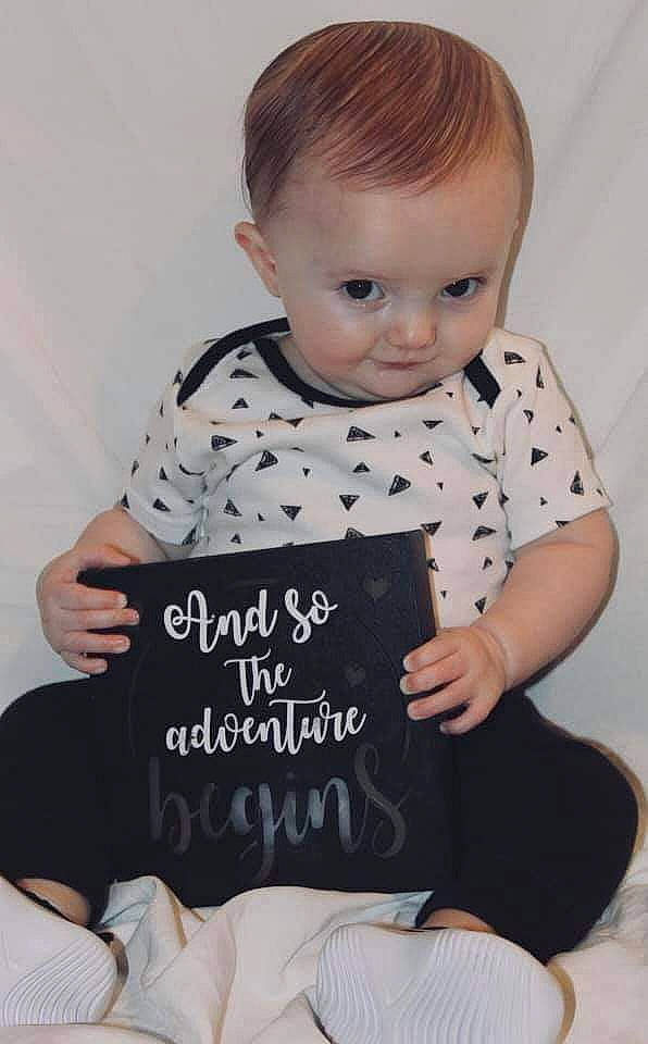 Sean joined the competition — help win amazing prizes! arm, baby_toddler_clothing, book, child, comfort, facial_expression, finger, hairstyle, hand, happy, human_body, mammal, pattern, person, product, publication, sleeve, t_shirt, table, thigh