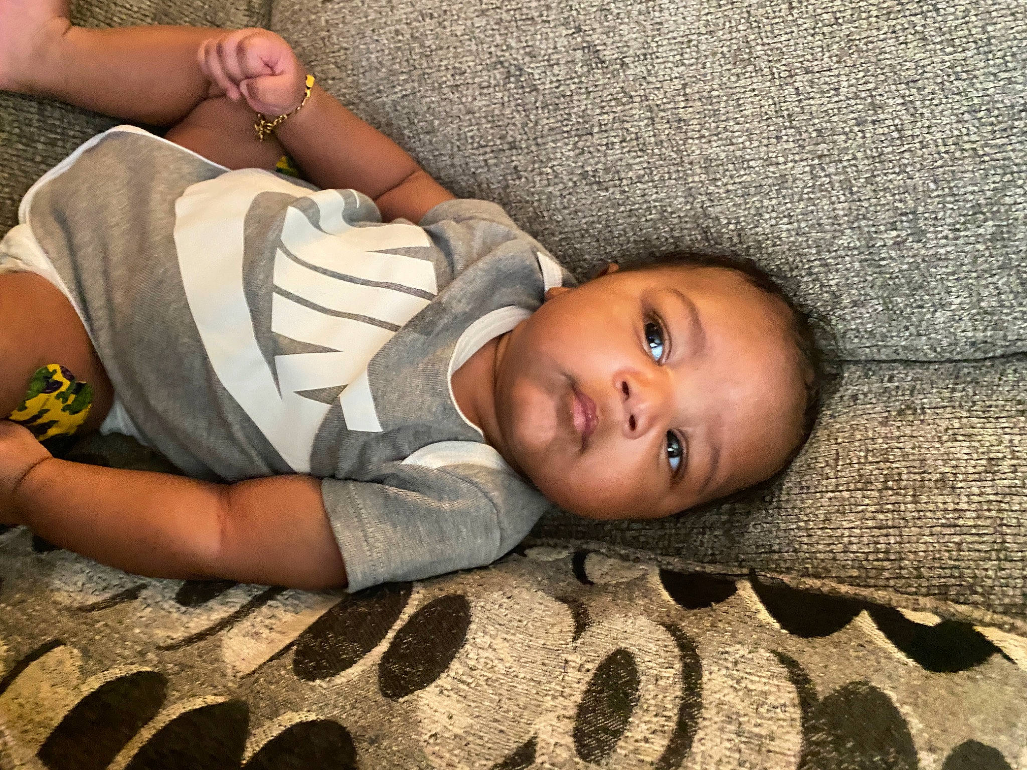 Makai joined the competition — help win amazing prizes! baby, chest, child, comfort, face, flash_photography, flooring, fun, glasses, happy, human_leg, joint, leg, person, sitting, skin, smile, thigh, toddler, tree