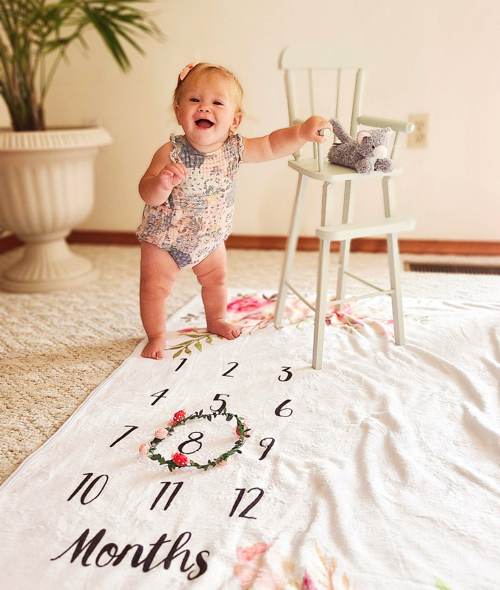 Blaire is registered to the contest to win money with this photo: art, baby, baby_toddler_clothing, chair, child, dress, floor, flooring, flowerpot, happy, hardwood, houseplant, illustration, person, plant, room, smile, t_shirt, table, toddler