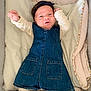 baby, infant, denim_dress, headband, blanket, bedding, smile, happy, cute, lying_down, arms_up, padded, cozy, child, portrait, soft, white_clothing, toddler, indoors, face