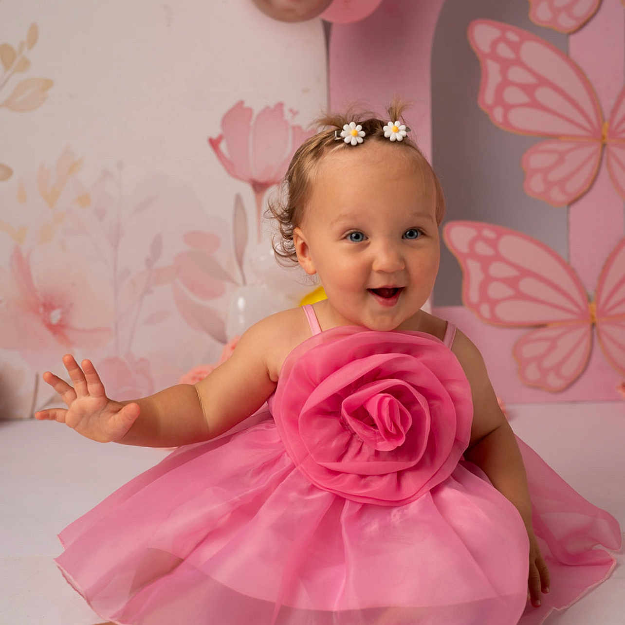Aja is registered to the contest to win money with this photo: baby, balloons, barefoot, butterfly_wall_art, celebration, child, curly_hair, cute, decor, flower_decoration, hair_accessories, happy, indoor, pastel_colors, pink_dress, playful, portrait, sitting, smiling, toddler