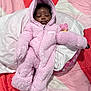 baby, infant, sleeping, pink_onesie, hooded_jumpsuit, pacifier, blanket, quilt, soft_fabric, cozy, child, cute, indoor, resting, newborn, clothing, person, fur_texture, relaxation, face