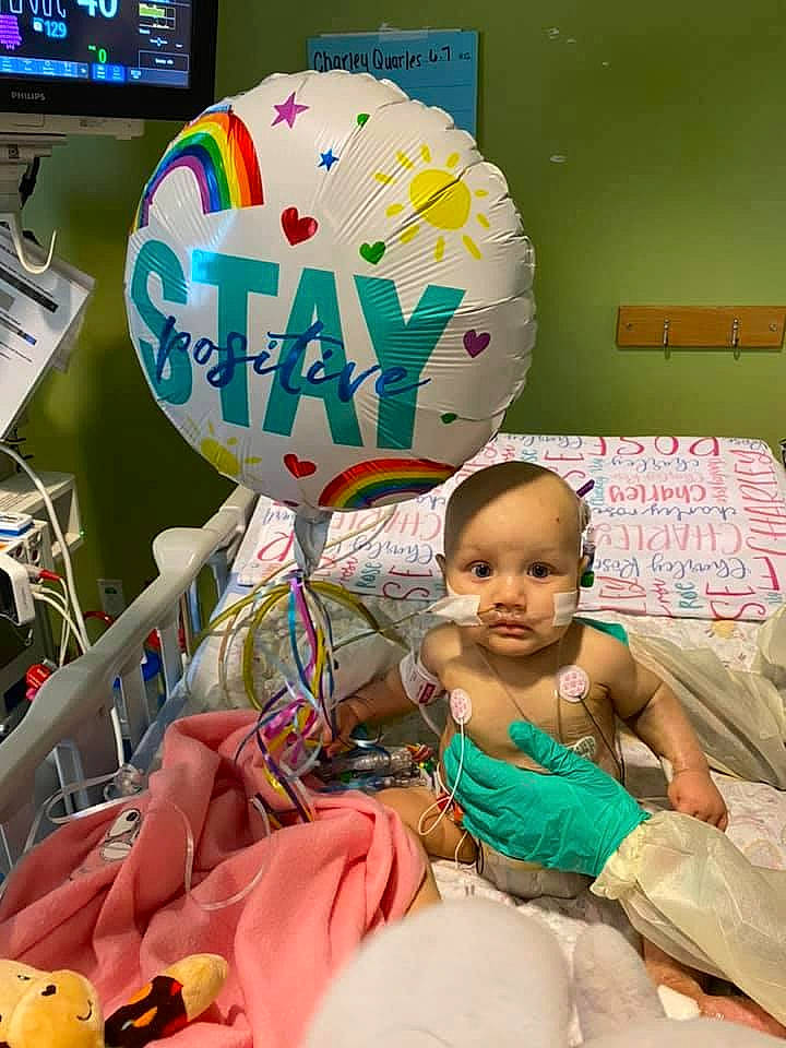 Charley is registered to the contest to win money with this photo: baby, balloon, child, computer_keyboard, display_device, event, fun, happy, leisure, party, party_supply, people, person, pink, play, room, snapshot, t_shirt, toddler, world