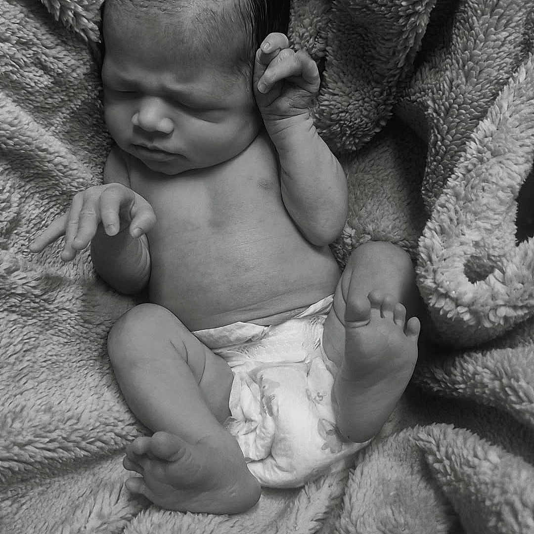Ja'Karie is registered to the contest to win money with this photo: newborn, baby, infant, diaper, blanket, sleeping, black_and_white, soft_texture, cute, peaceful, small_hands, small_feet, wrapped, cozy, portrait, human, child, resting, indoors, closeup