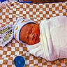 Ja'Karie is registered to the contest to win money with this photo: newborn, baby, sleeping, hat, bunny_ears, blanket, checkered, pacifier, swaddled, cozy, infant, cute, resting, soft, striped, sleep, portrait, child, indoors, nostalgic