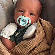 Arlo is registered to the contest to win money with this photo: baby, newborn, pacifier, blanket, mittens, infant, face, cushion, seat, closeup, cozy, resting, child, cute, warm, sleepwear, portrait, indoor, soft, comfort