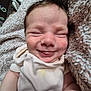 baby, smile, tongue_out, blanket, onesie, infant, close_up, soft_texture, cute, happy, sleepy, child, newborn, cozy, indoor, face, expression, skin, head, comfort