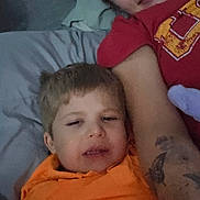 Bentley is registered to the contest to win money with this photo: adult, bed, candid, casual, child, closeup, face, family, hair, indoor, orange_shirt, person, pillow, red_shirt, relaxed, selfie, skin, smile, tattoo, together