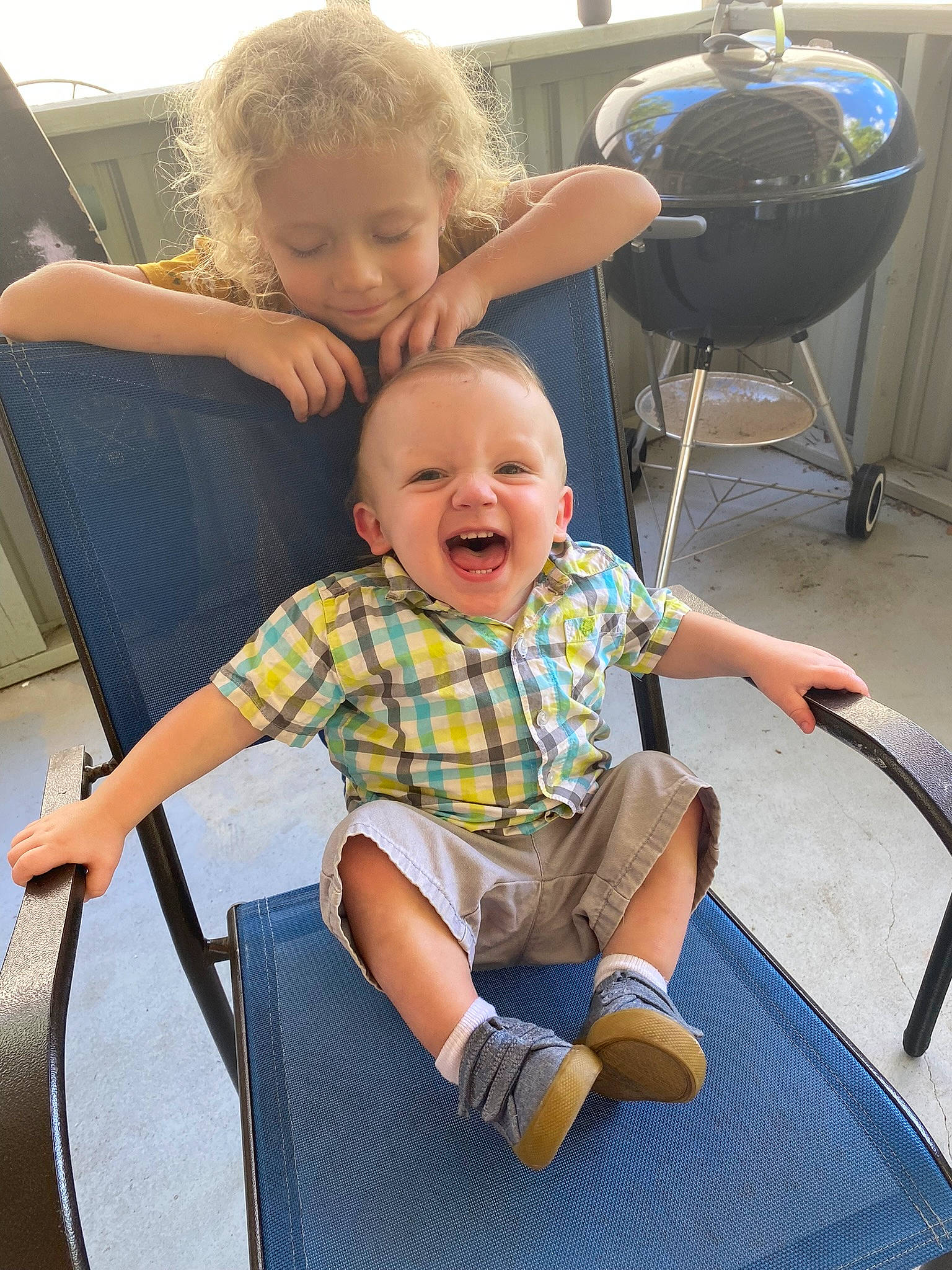 Bryson is registered to the contest to win money with this photo: blue, chair, child, eye, face, finger, fun, hair, happy, joint, lap, leg, leisure, person, product, shorts, shoulder, skin, smile, standing
