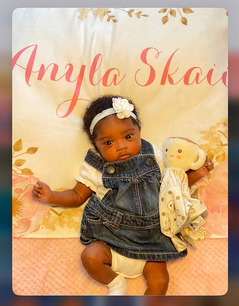 Anyla is registered to the contest to win money with this photo: baby, baby_toddler_clothing, child, doll, dress, fashion_accessory, font, fur, happy, hat, headband, headpiece, magenta, pattern, peach, person, photo_caption, pink, sleeve, toddler