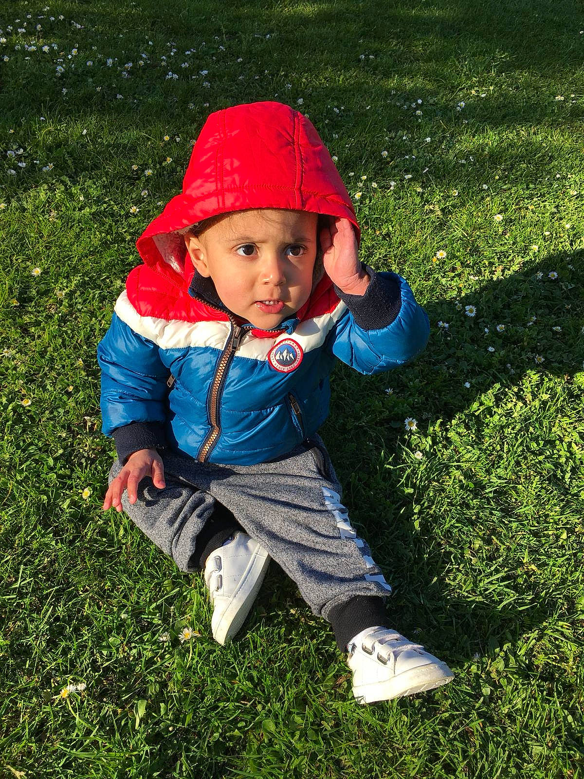 Dakarai is registered to the contest to win money with this photo: baby, child, garden, grass, green, headwear, lawn, leaf, outerwear, person, plant, play, smile, toddler, tree, vacation