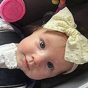 Miley joined the competition — help win amazing prizes! baby, infant, child, face, headband, blue_eyes, car_seat, toy, pink, yellow, clothing, cute, closeup, soft_light, portrait, seatbelt, fabric, comfort, young, adorable