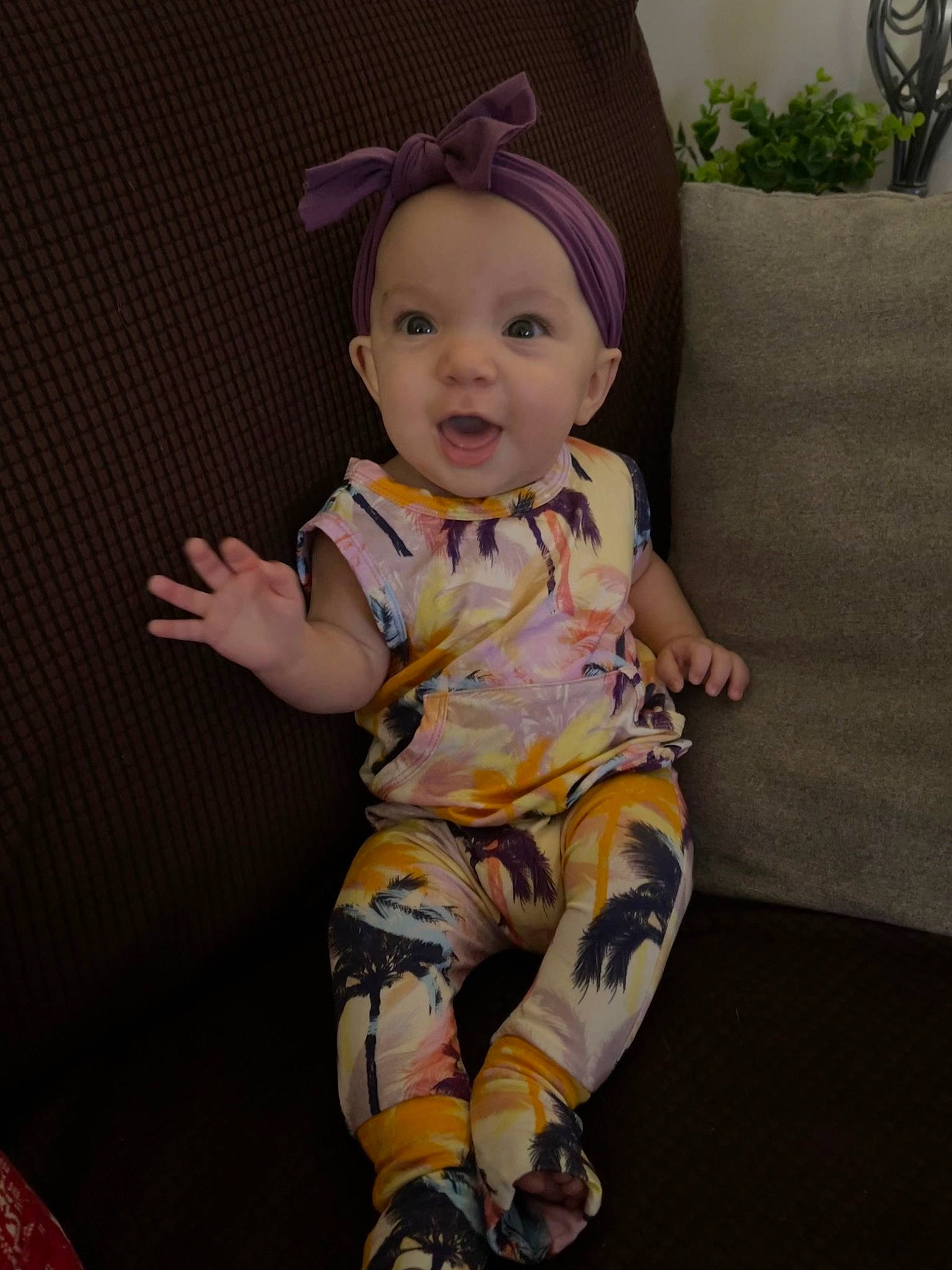 Adley is registered to the contest to win money with this photo: baby, baby_toddler_clothing, cap, cheek, cool, couch, eye, finger, happy, hat, head, houseplant, human_body, iris, knee, person, sleeve, smile, t_shirt, textile