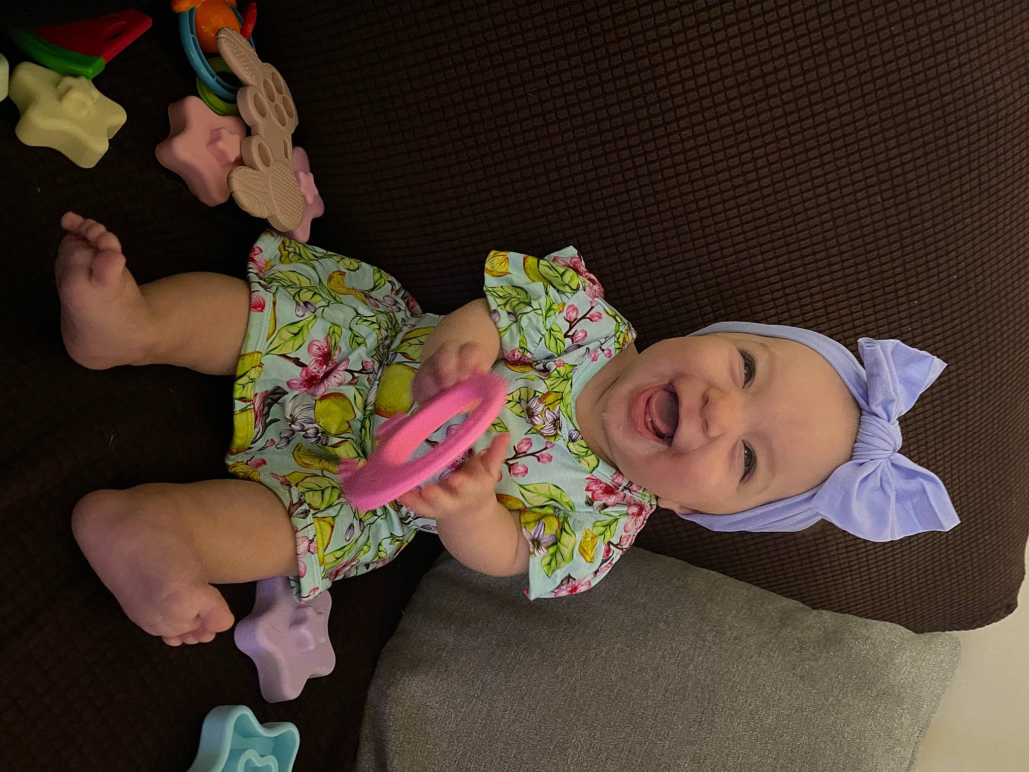 Adley is registered to the contest to win money with this photo: baby, baby_products, baby_toddler_clothing, child, comfort, foot, hat, head, headgear, headwear, human_leg, knee, lap, pattern, person, sitting, sleeve, smile, sock, textile