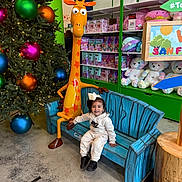 Kailani joined the competition — help win amazing prizes! boy, child, clothing, couch, face, footwear, furniture, head, indoors, interiordesign, male, pants, person, photography, plant, portrait, shoe, sitting, toy, tree
