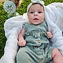 Romy participe au concours pour gagner de l'argent avec cette photo : baby, infant, romper, headband, blanket, grass, outdoor, flower_vase, dried_flowers, greenery, cute, portrait, child, soft_texture, natural_light, summer, peaceful, baby_clothes, closeup, relaxing
