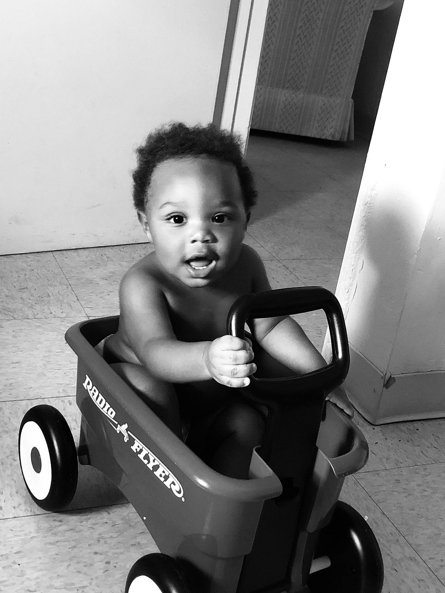 Jaylyn joined the competition — help win amazing prizes! black, black_and_white, child, person, photography, product, riding_toy, sitting, style, toddler, vehicle